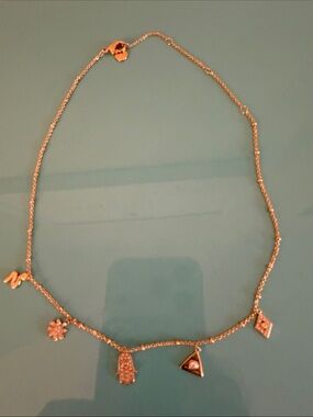 Stella & Dot rose gold charm necklace with Hamsa and geometric pendants